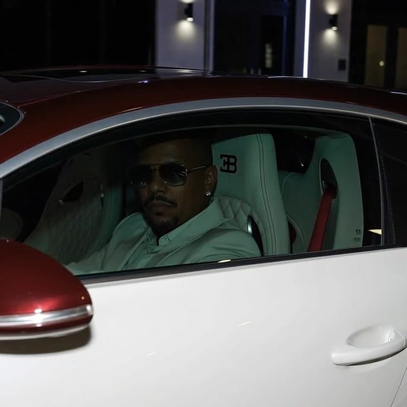 CARMINE in front of a Bugatti, representing the dark luxury era of the sound.